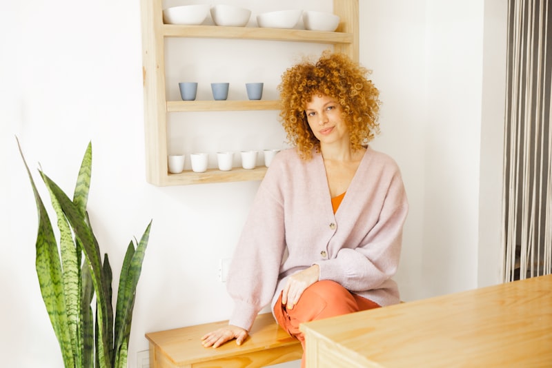 Frau in hellem Zimmer mit Pflanze — warme Atmosphäre für das Erstgespräch